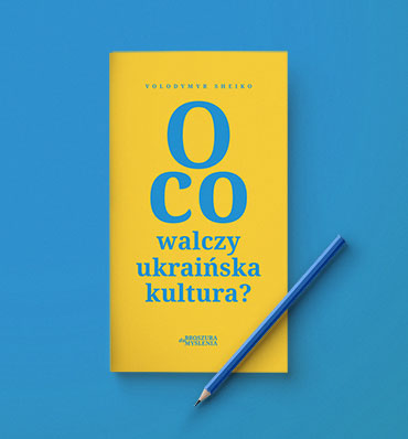 Żółta okładka broszury z typograficzną okładką, na broszurze leży ołówek